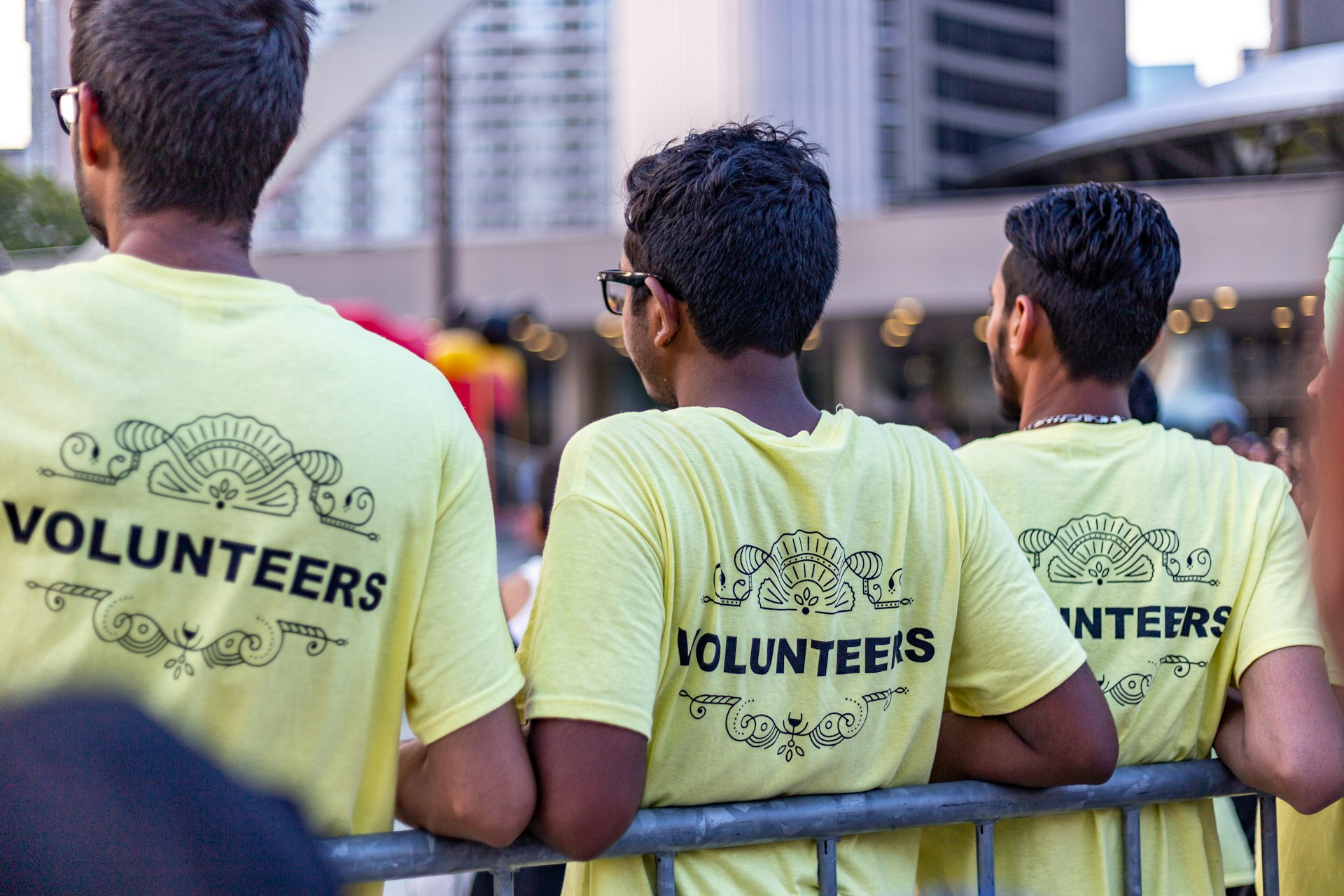 Group of volunteers wearing volunteer t-shirts working together at a community event